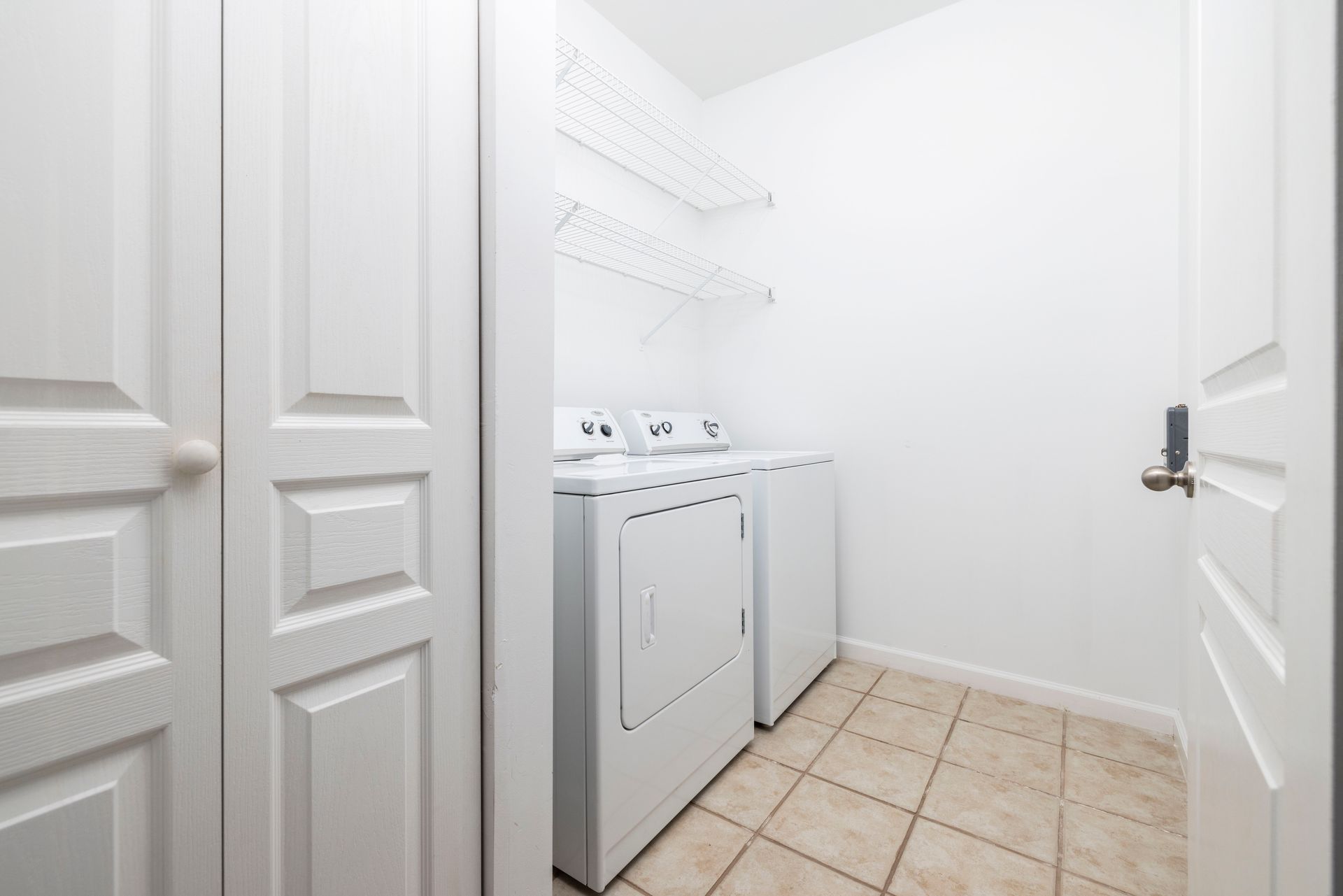 A laundry room with a washer and dryer in it | The Grove at Oakbrook