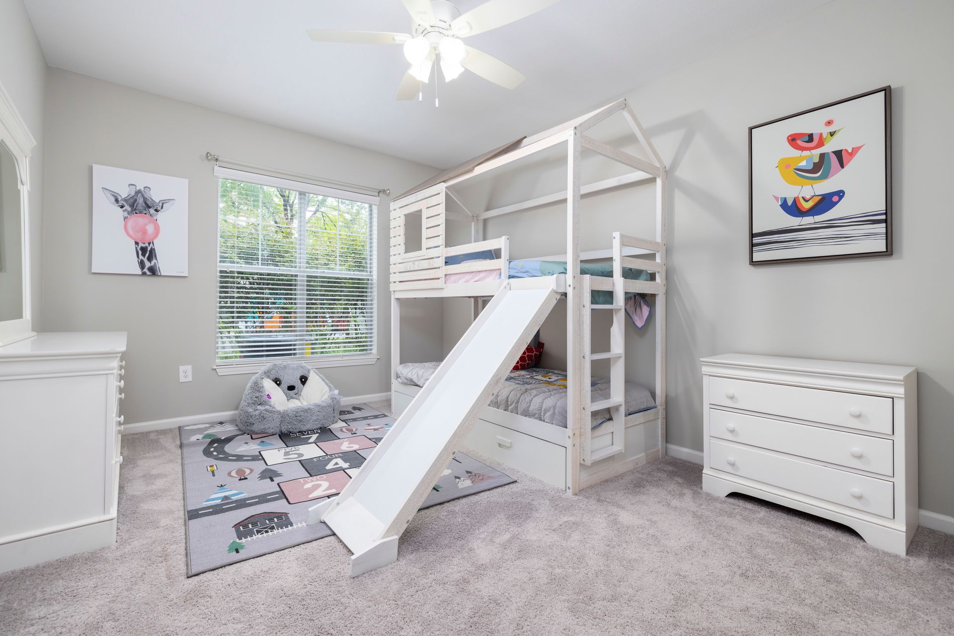 A bedroom with a bunk bed and a slide | The Grove at Oakbrook