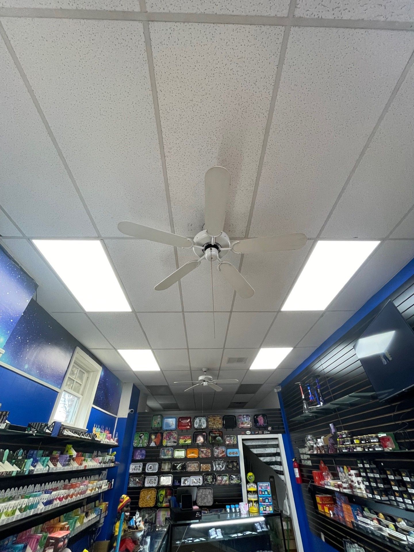 A ceiling fan is hanging from the ceiling of a store.