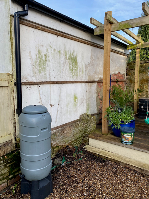 side of a garage and a water butt