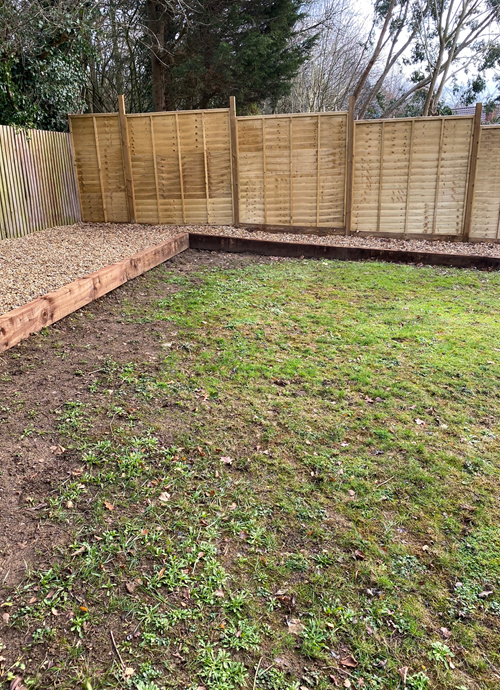 empty garden space leading to fencing