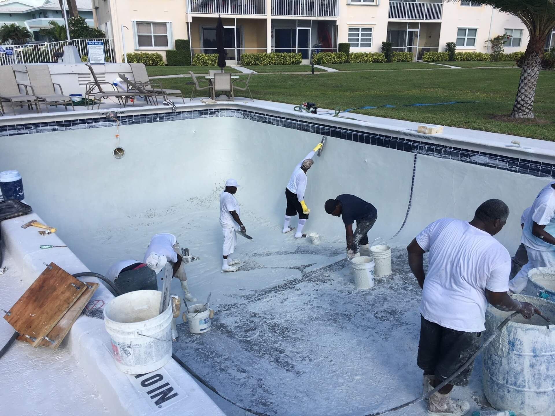 A group of people are working on a swimming pool.