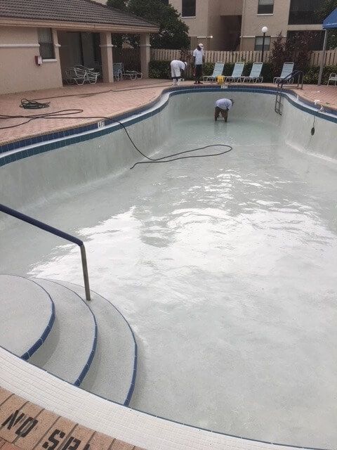A swimming pool with a no swimming sign on the side.