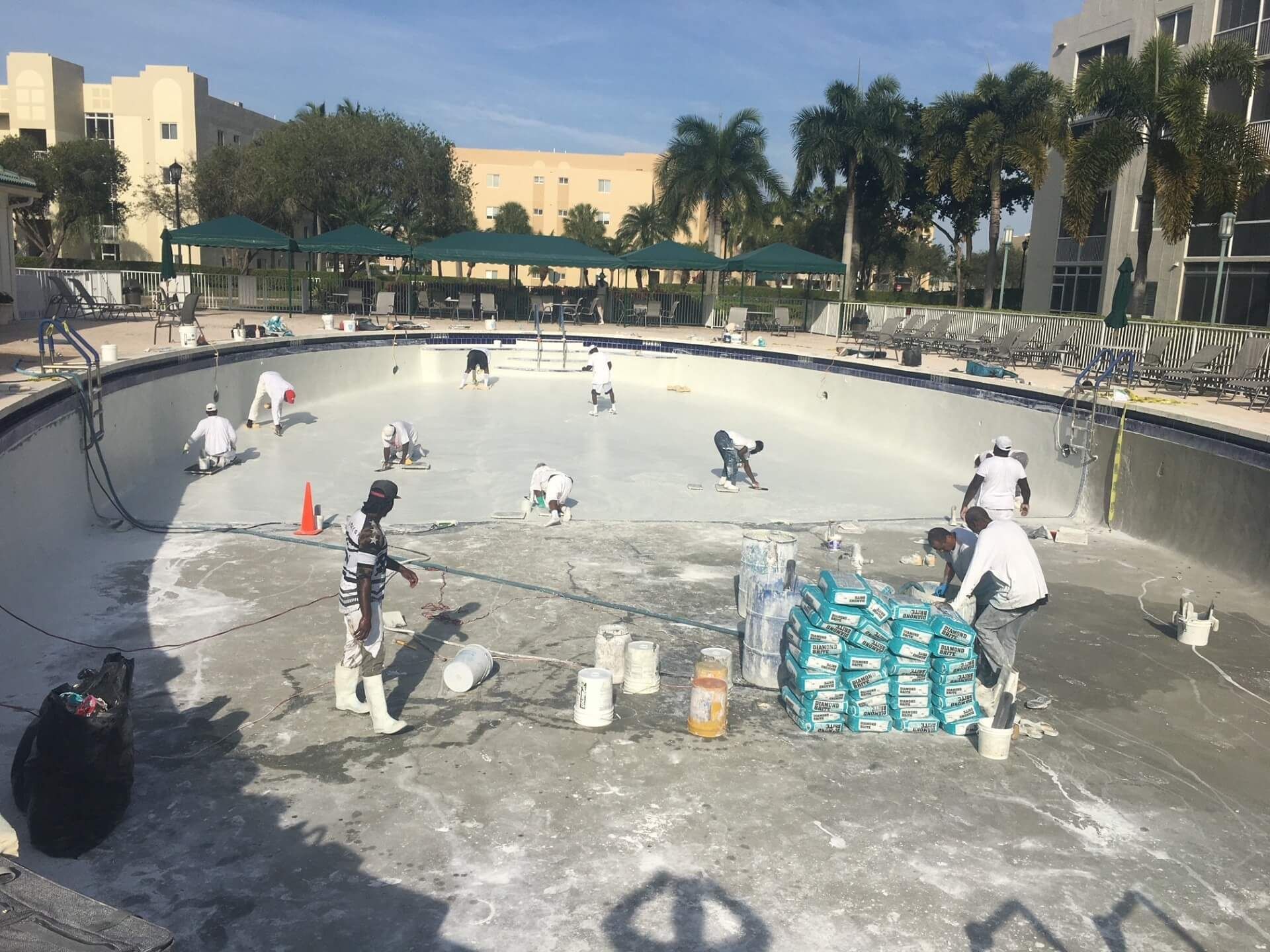 A group of people are working on a swimming pool.
