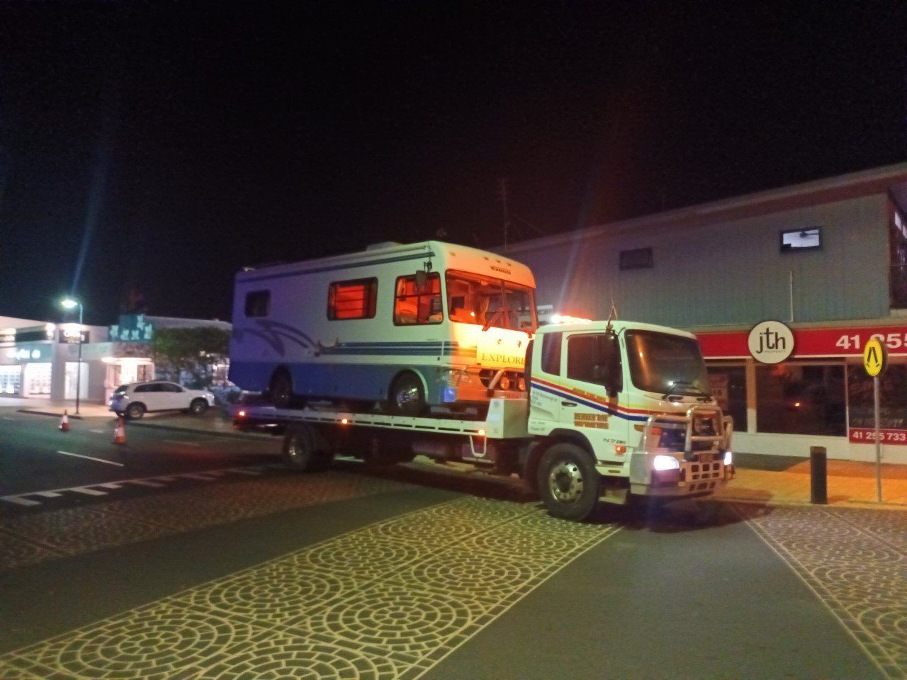 A RV is Being Towed by a Tow Truck — Hervey Bay Tilt Tray Hire In Bundaberg, QLD