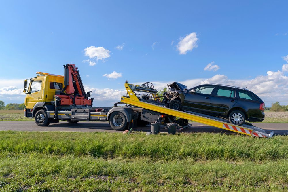 A Tow Truck is Towing a Car on a Ramp — Hervey Bay Tilt Tray Hire In Takura, QLD