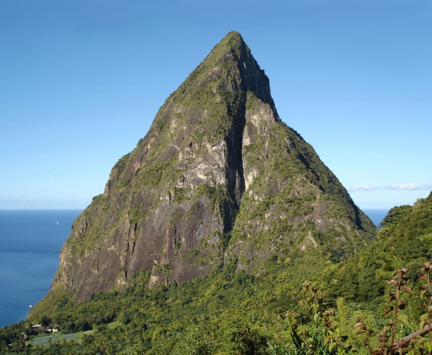 A large mountain with a blue sky in the background