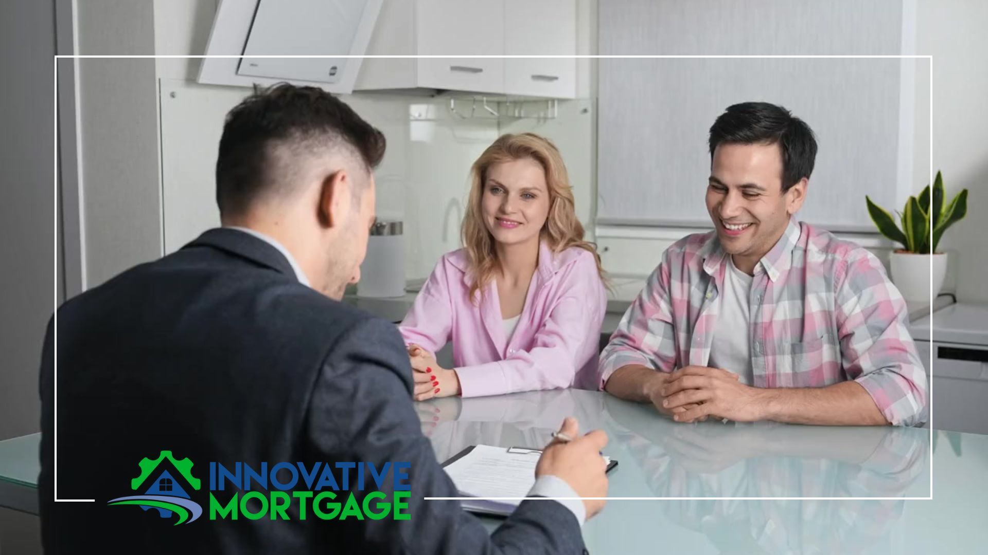 A man is sitting at a table talking to a couple about mortgage options.