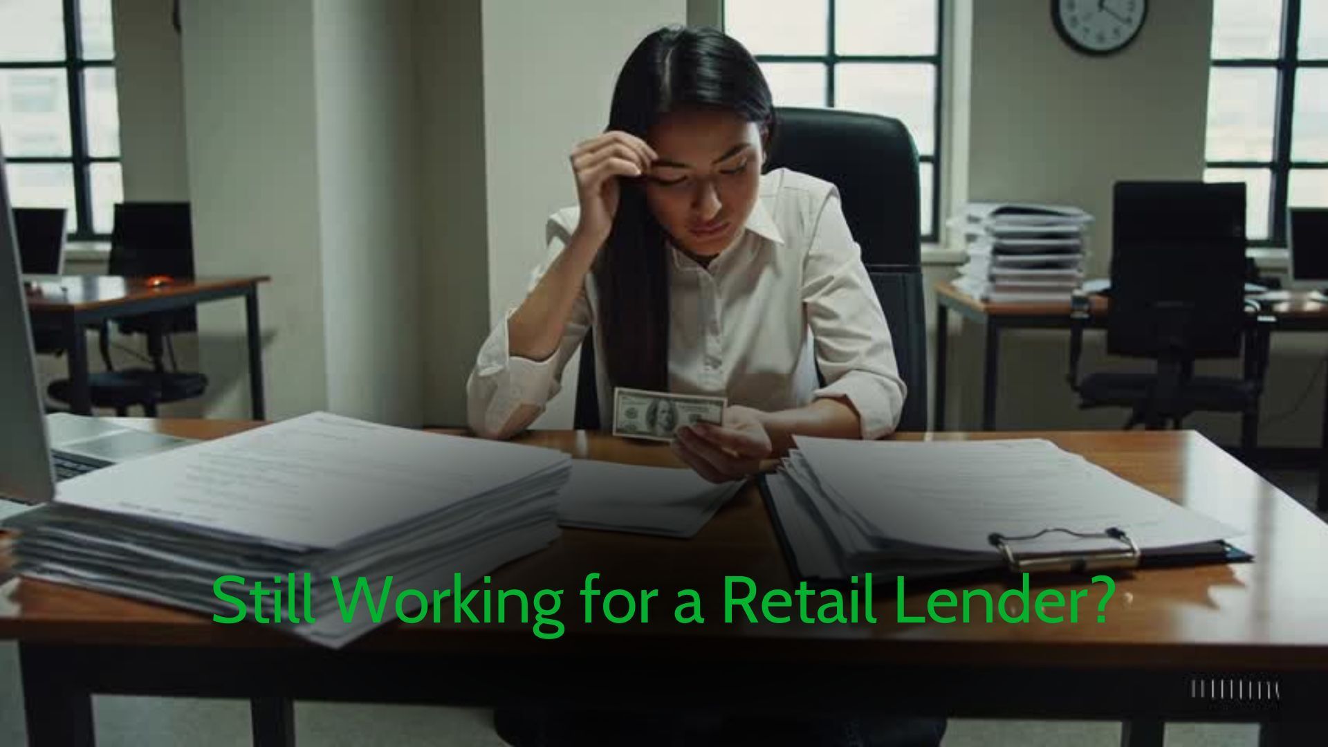 An MLO is sitting at a desk staring at a small bill.
