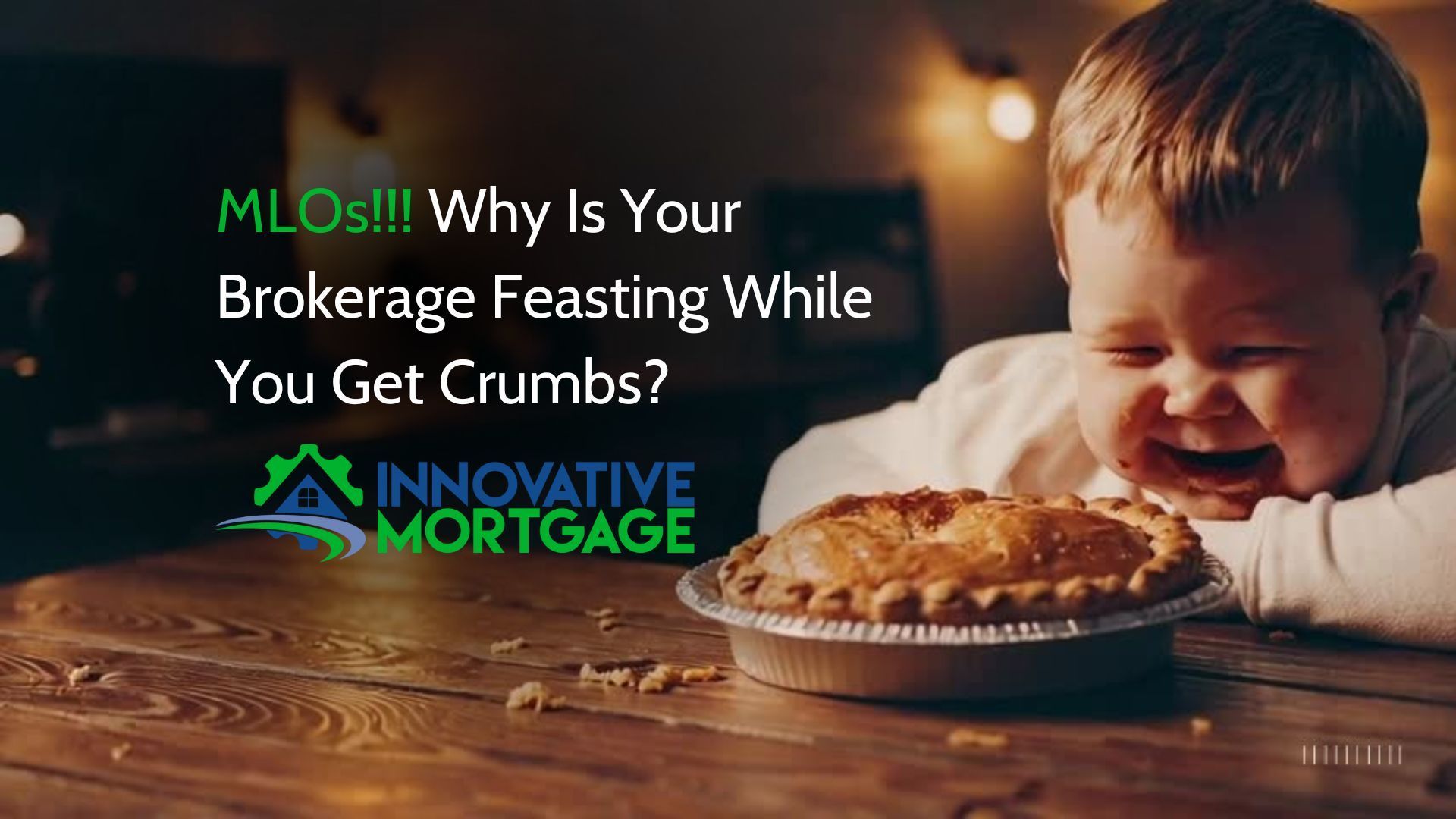 A baby is eating a pie on a wooden table.