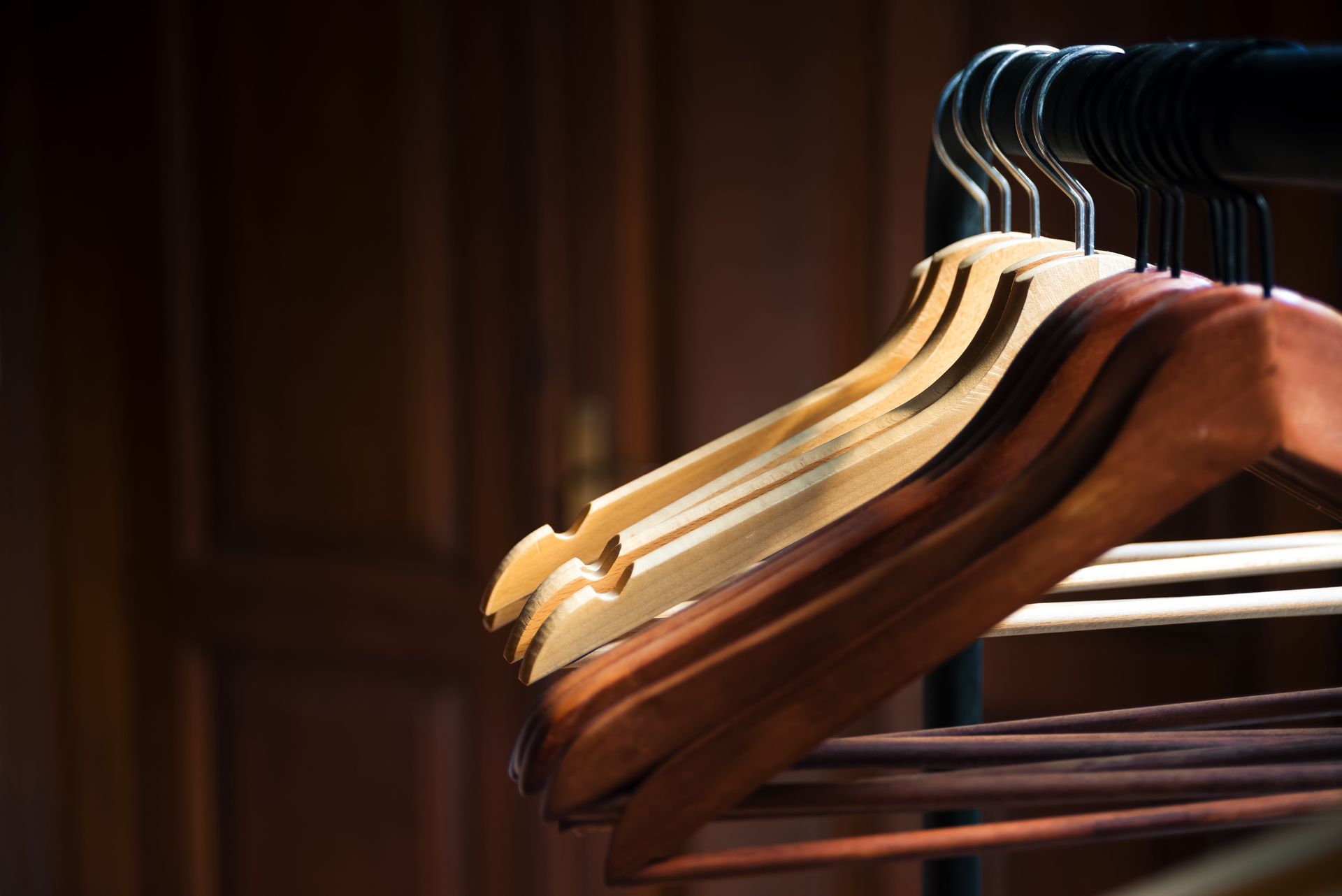 A row of wooden hangers hanging on a rack