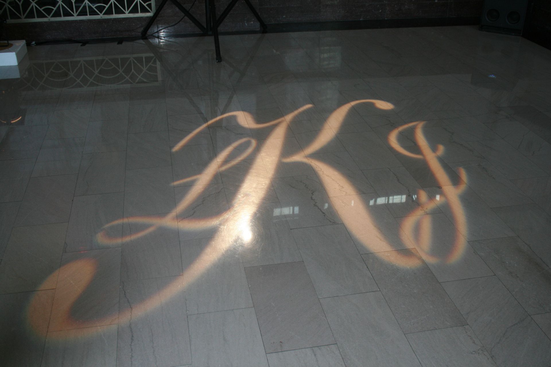 The letters k and s are projected on the floor
