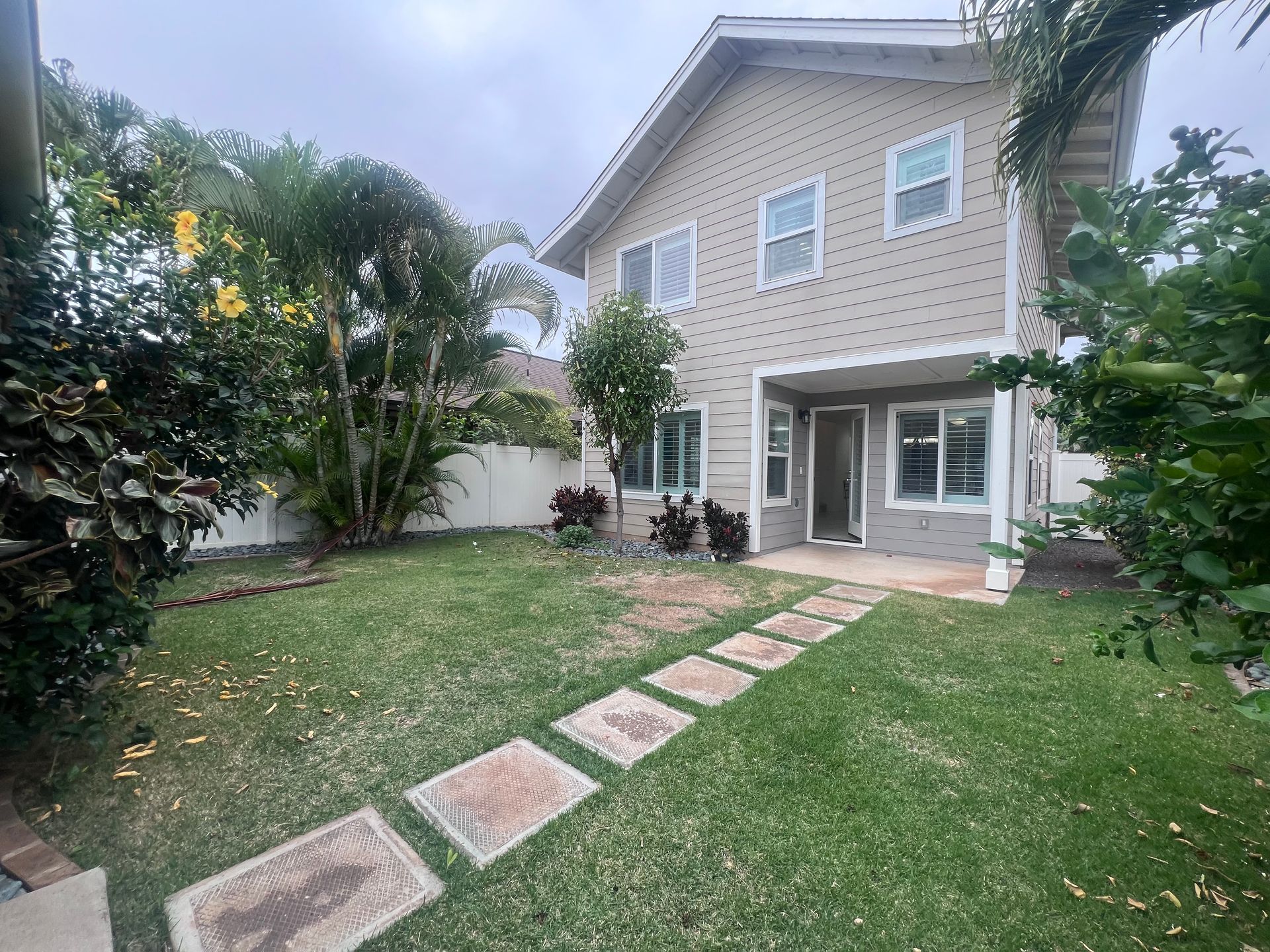 A large house with a lush green lawn in front of it.
