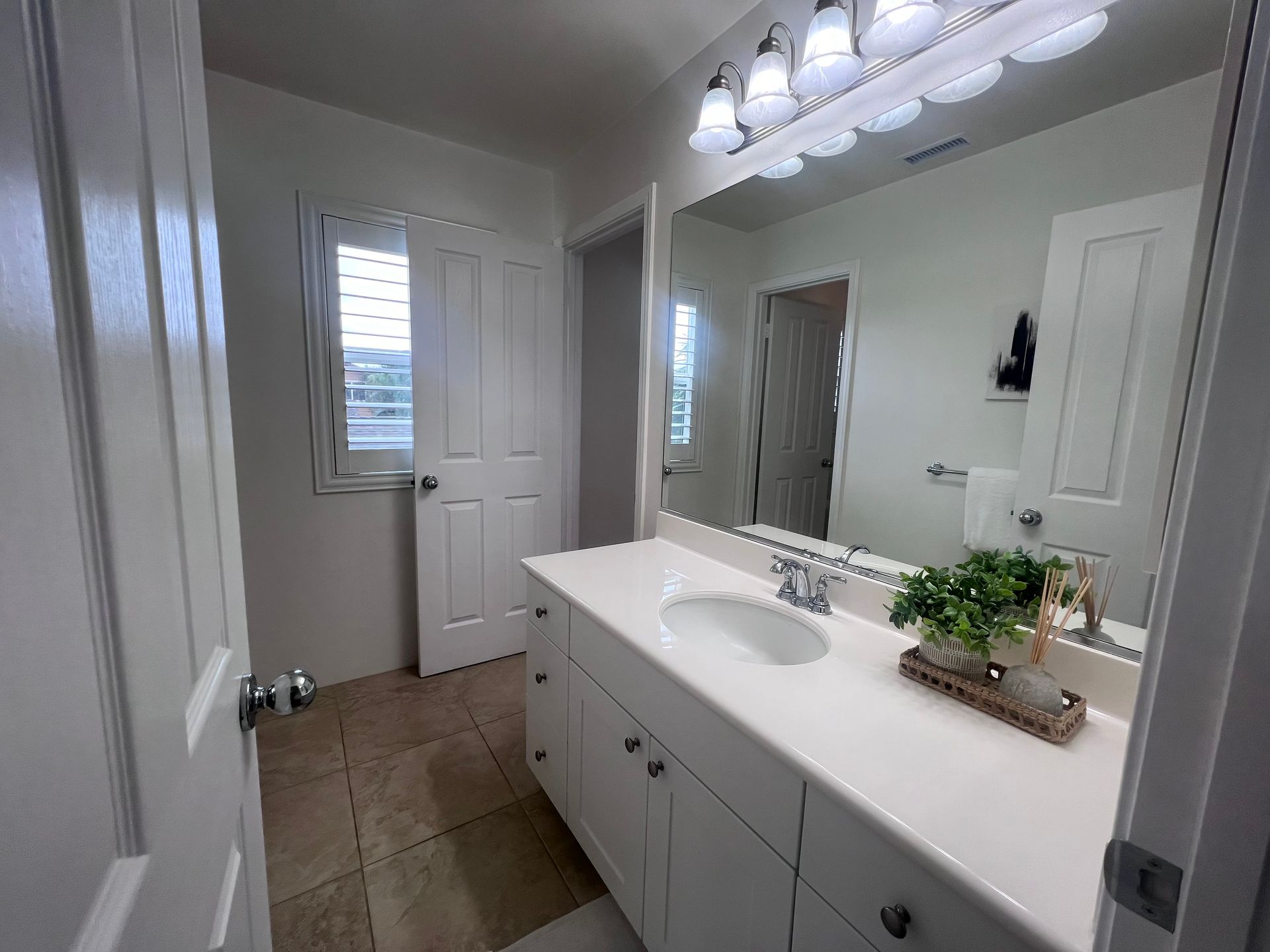 A bathroom with a double sink and a large mirror.