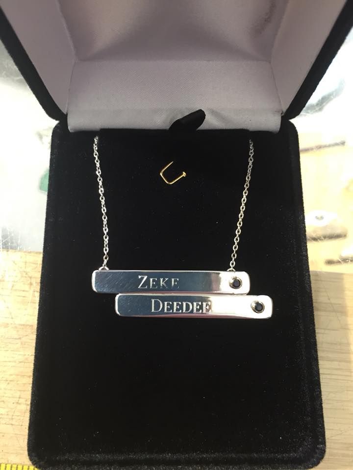 Silver bar necklace in a black velvet jewelry box; engraved with 