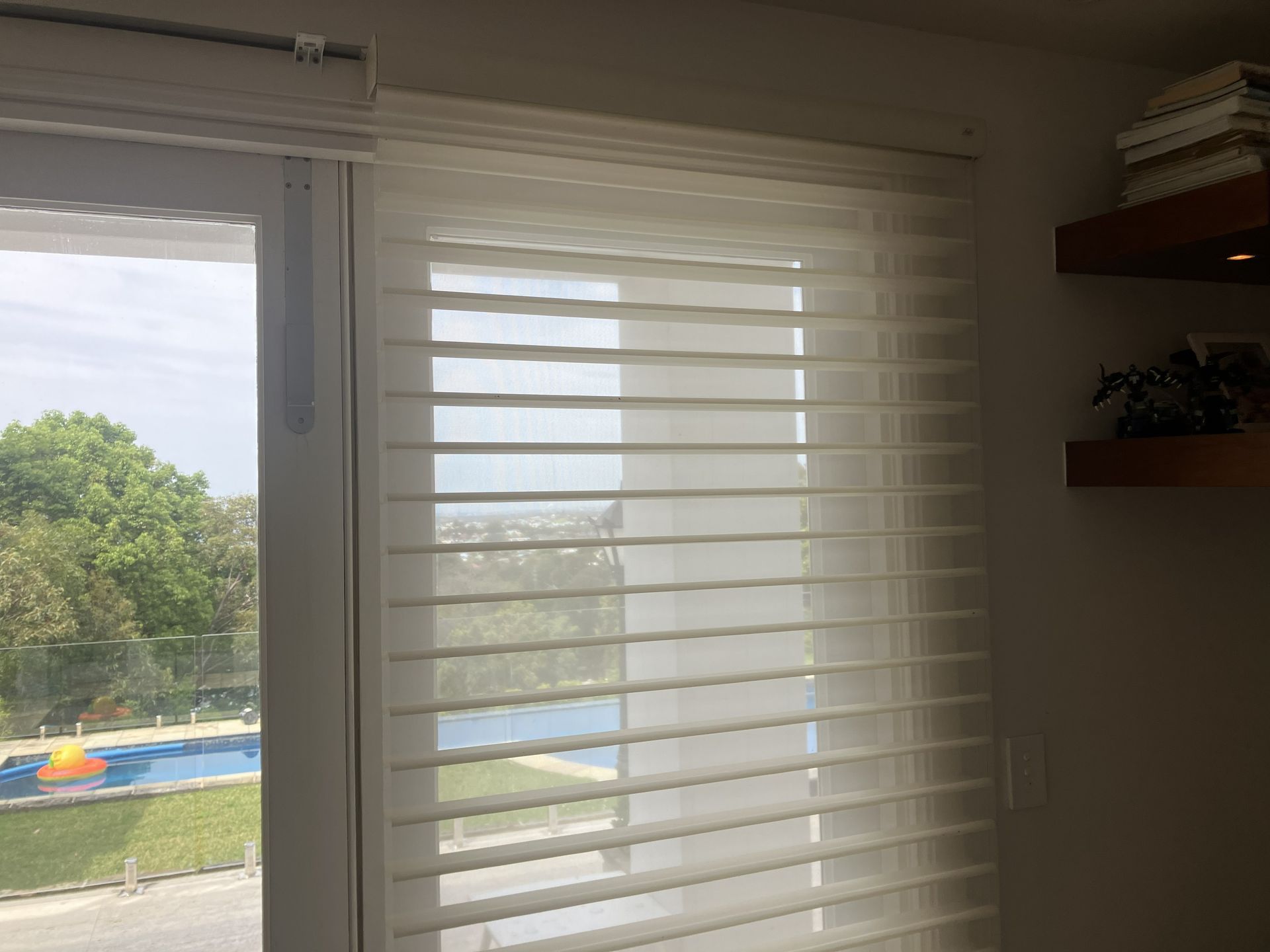 Close-up of wooden window blinds with warm sunlight filtering through the slats