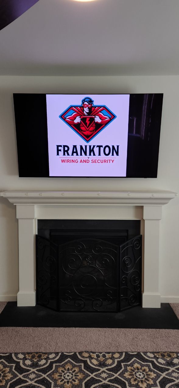 TV above fireplace showing Frankton logo in a living room