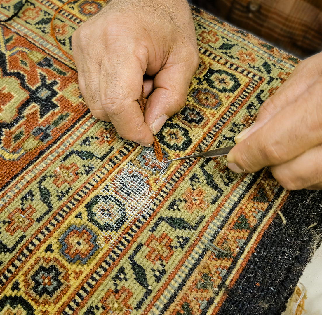 A man is working on a rug in a store.
