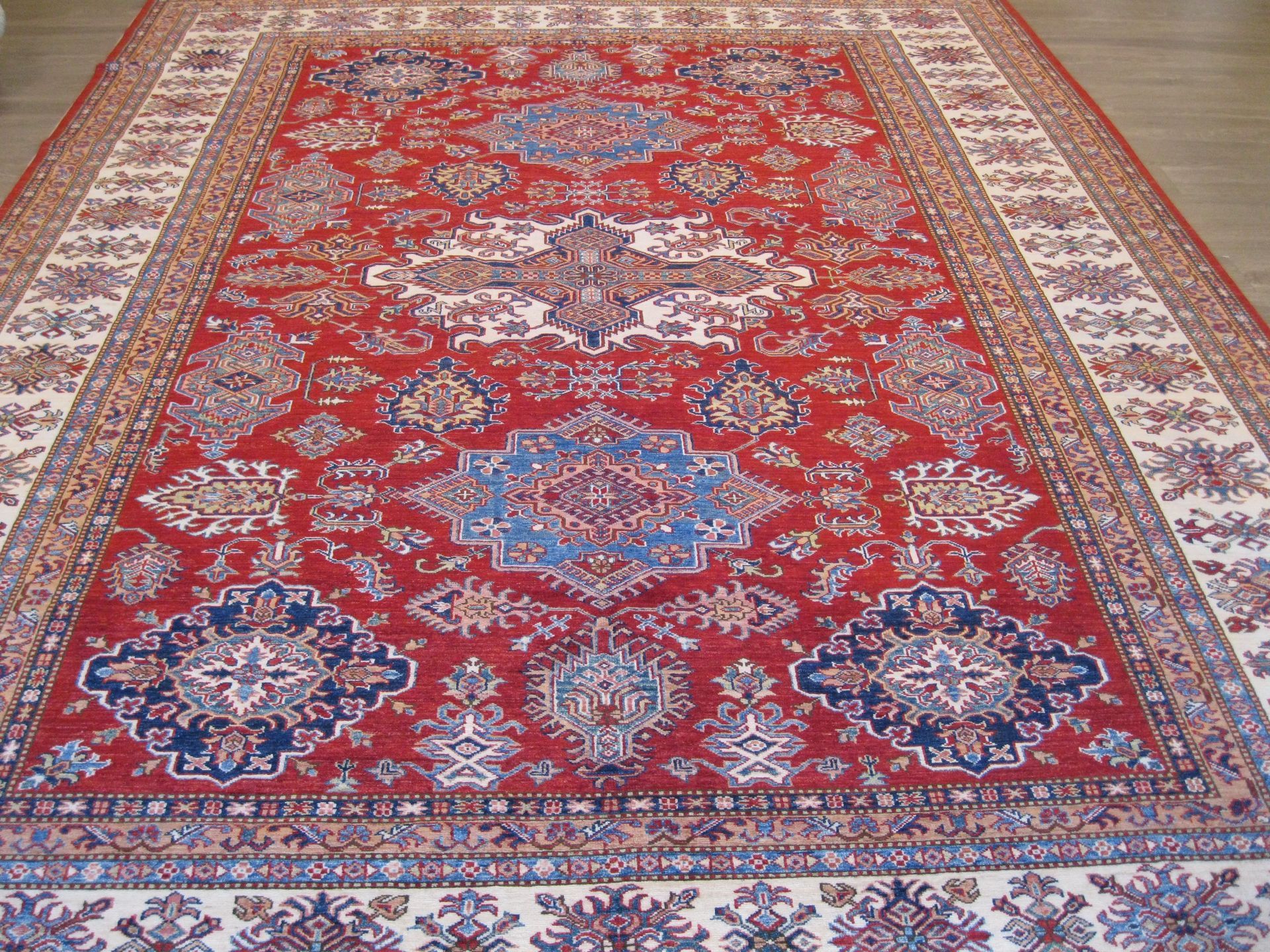 A red rug with a blue and white pattern on it