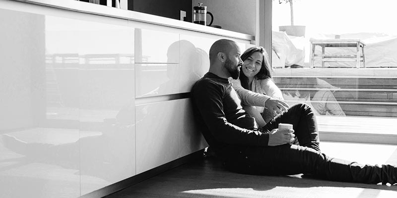 couple sitting on kitchen floor