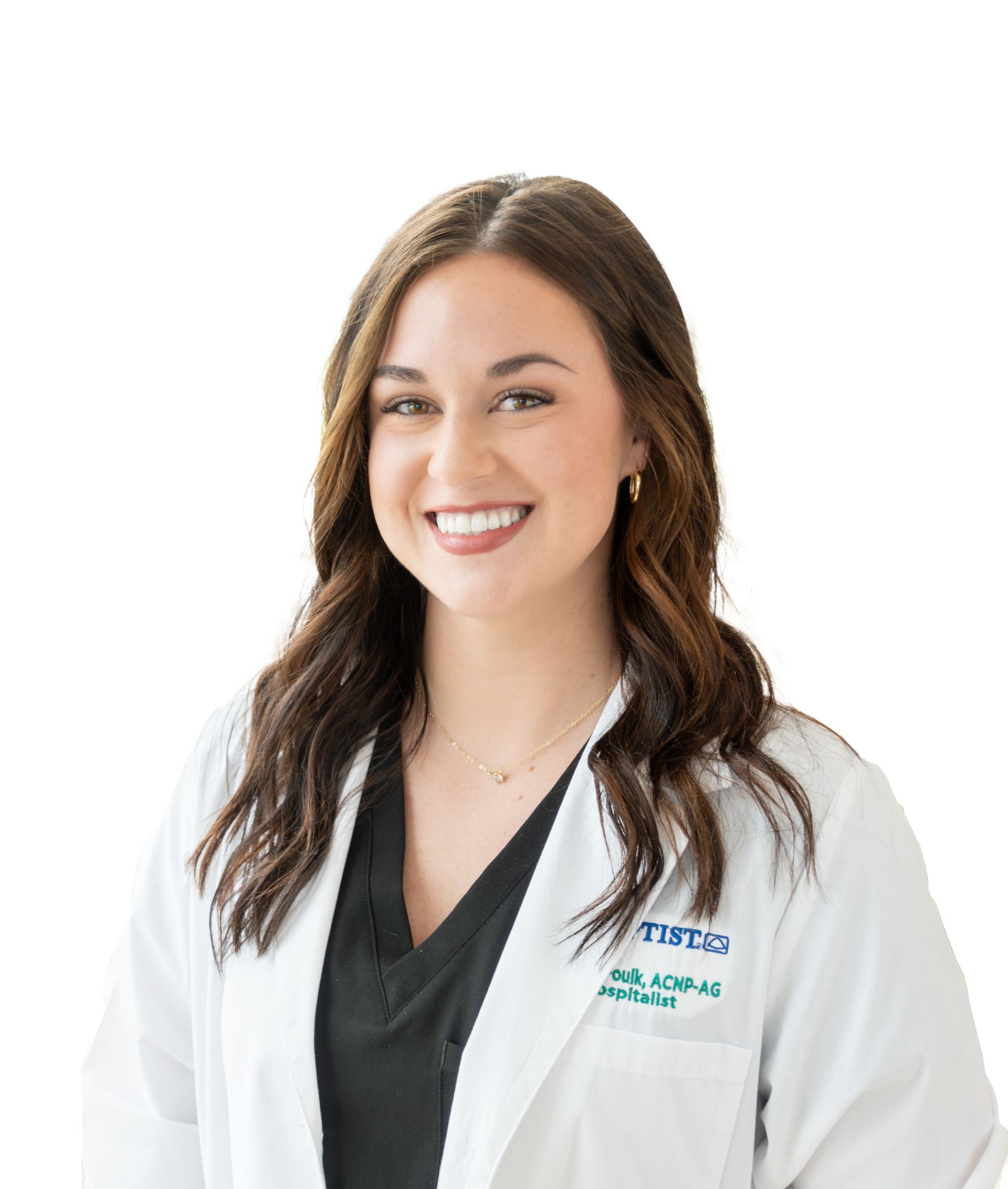 A woman in a white lab coat is smiling in front of a window.