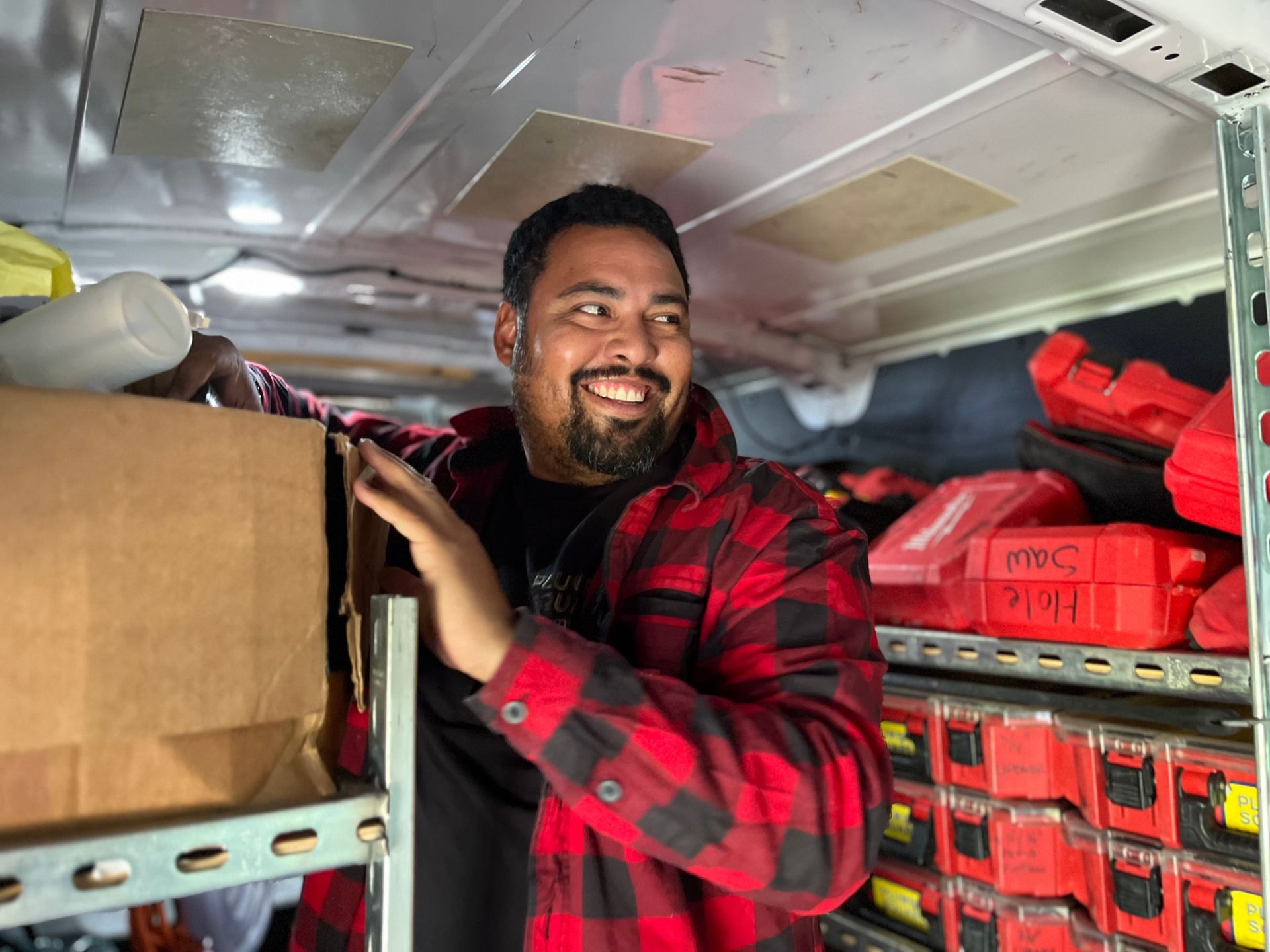 Rigo Rodriguez, owner of Plumbing Company Plumb & Square stands in front of his Plumbing van before doing a Plumbing job