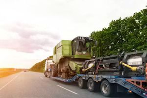 Dump truck dumping gravel on a construction site near the water, blue sky.