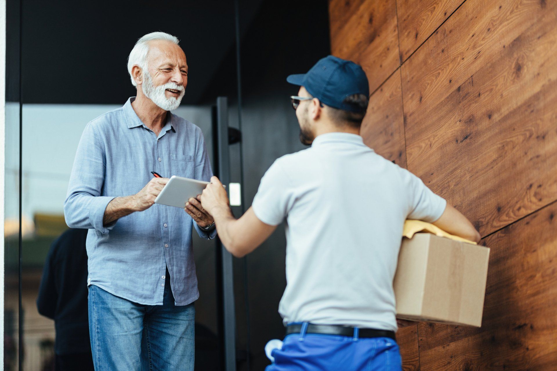 Happy Senior Man Communicating with a Courier — Court Beloit, WI — Christofferson Moving & Storage