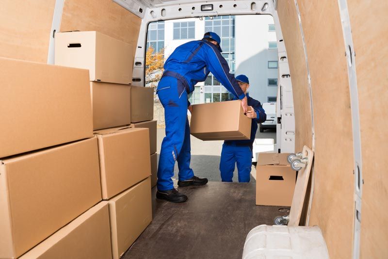Delivery Men Loading Cardboard Boxes — Court Beloit, WI — Christofferson Moving & Storage