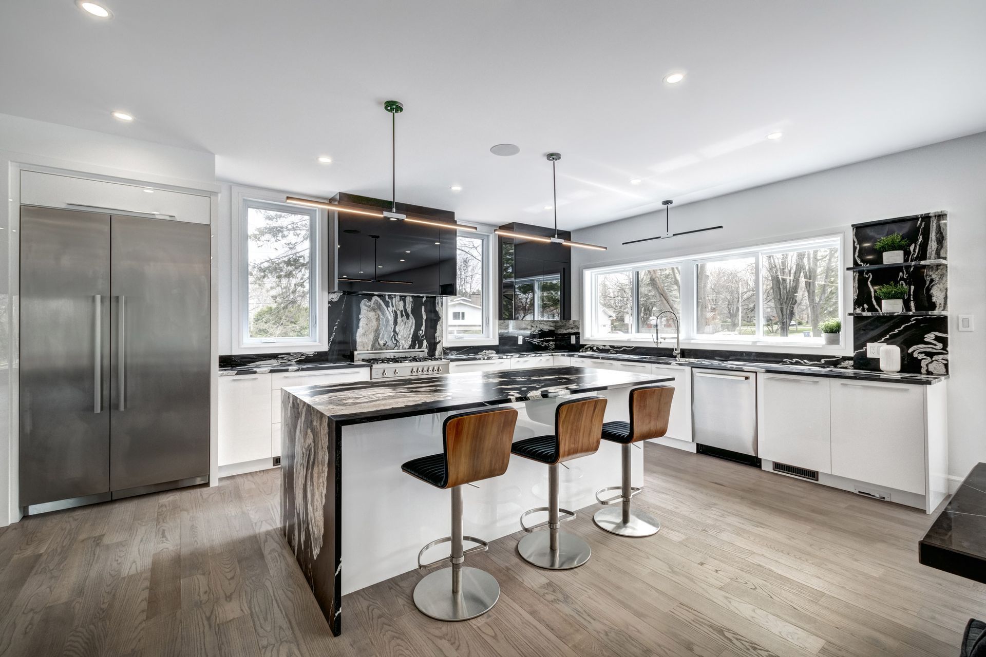 A large kitchen with stainless steel appliances and a large island.