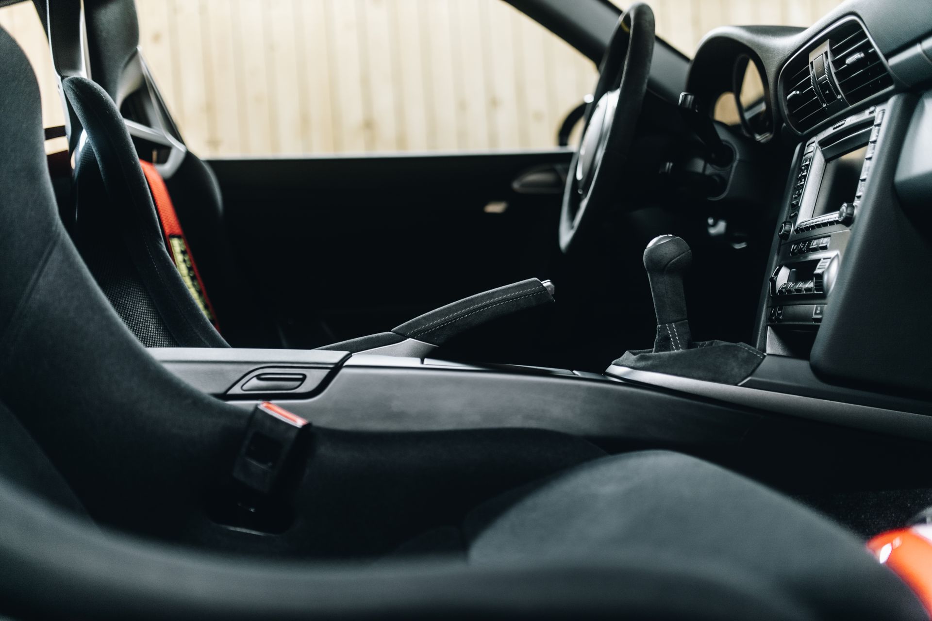 A close up of the interior of a car with a steering wheel and seats.