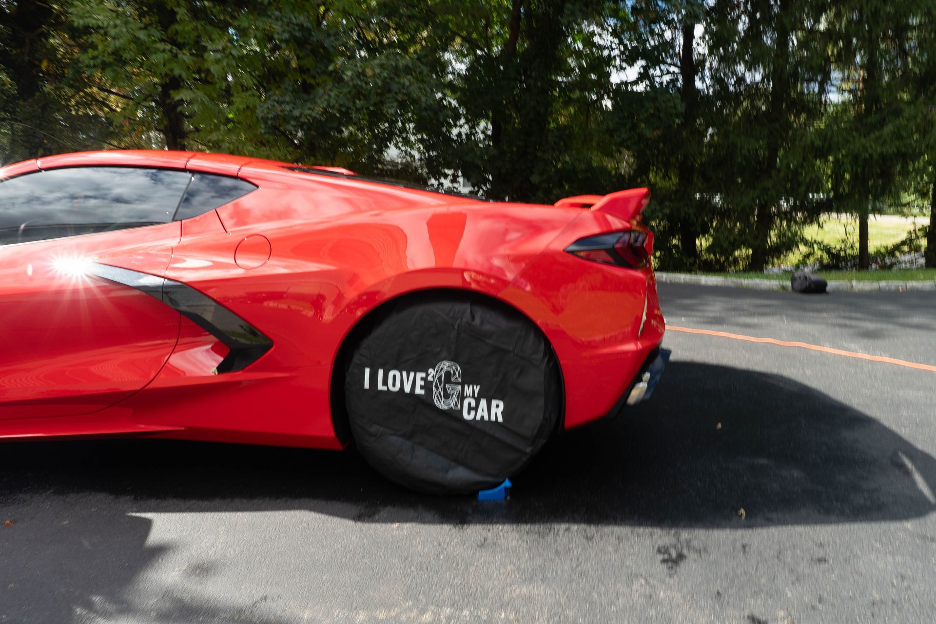 A red sports car is parked on the side of the road.