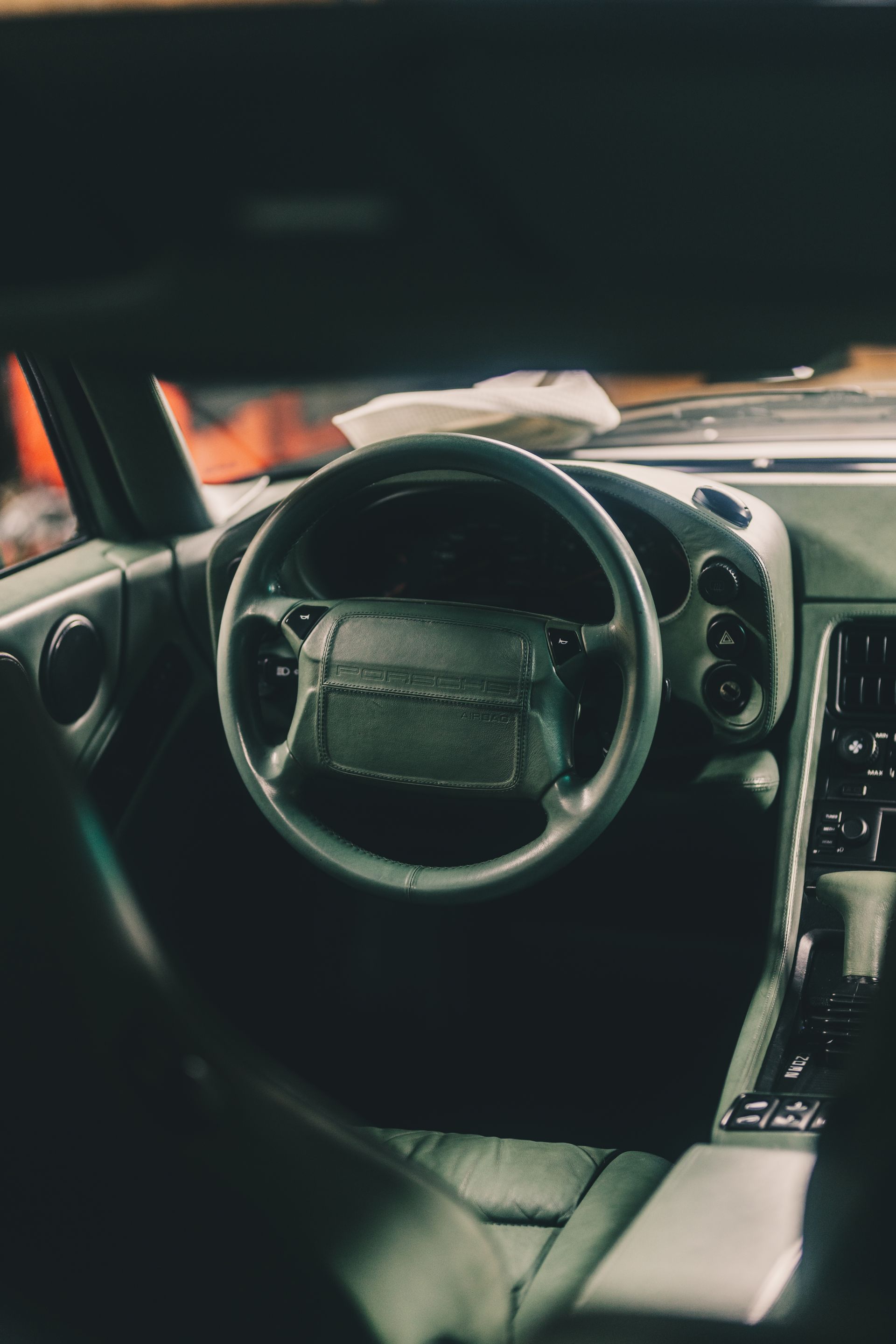 the inside of a car with a steering wheel and dashboard .