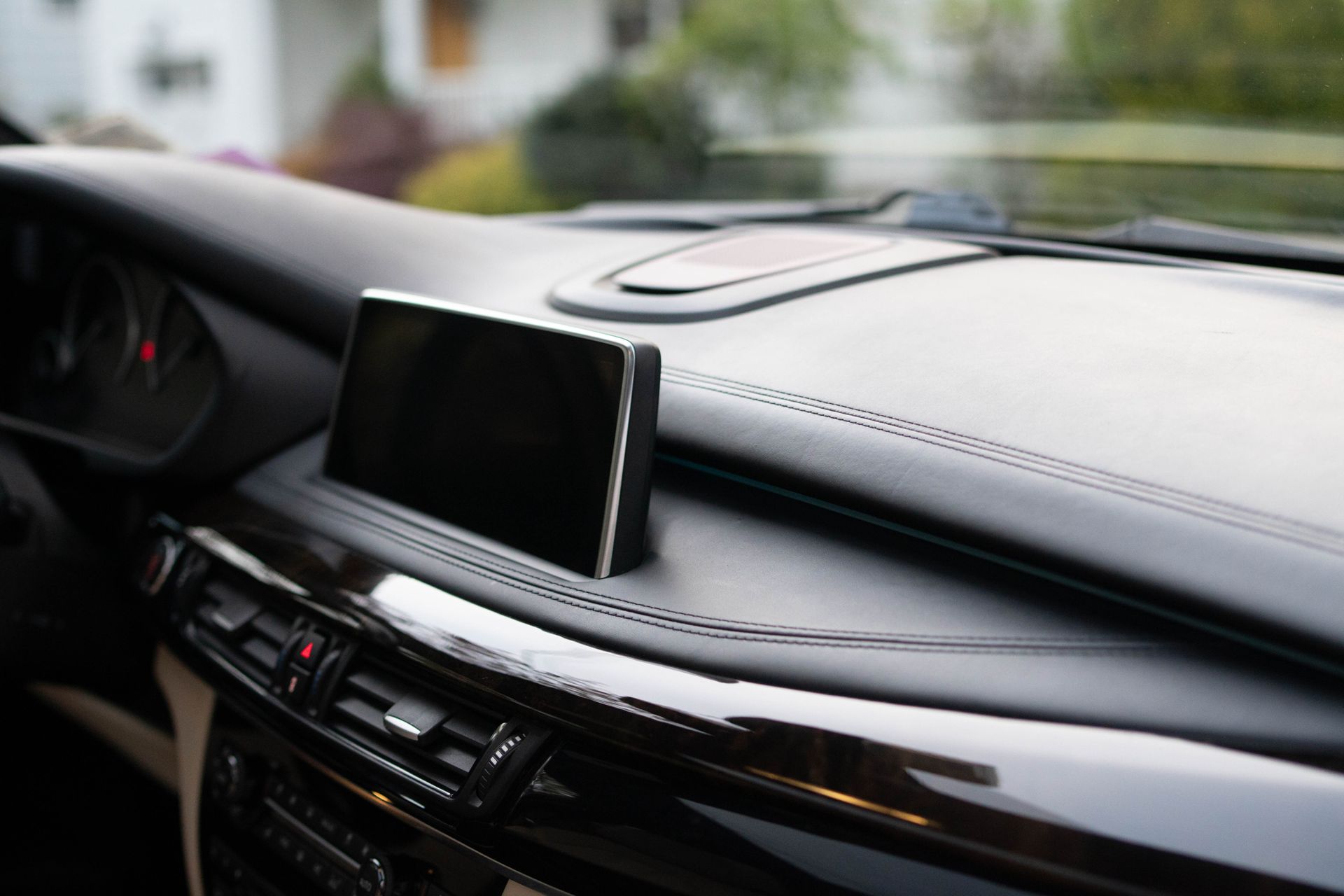 Car dashboard with navigation screen and leather trim freshly cleaned and detailed