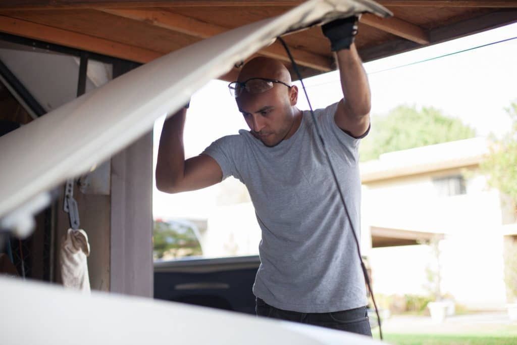 Man checking under the hood of his car