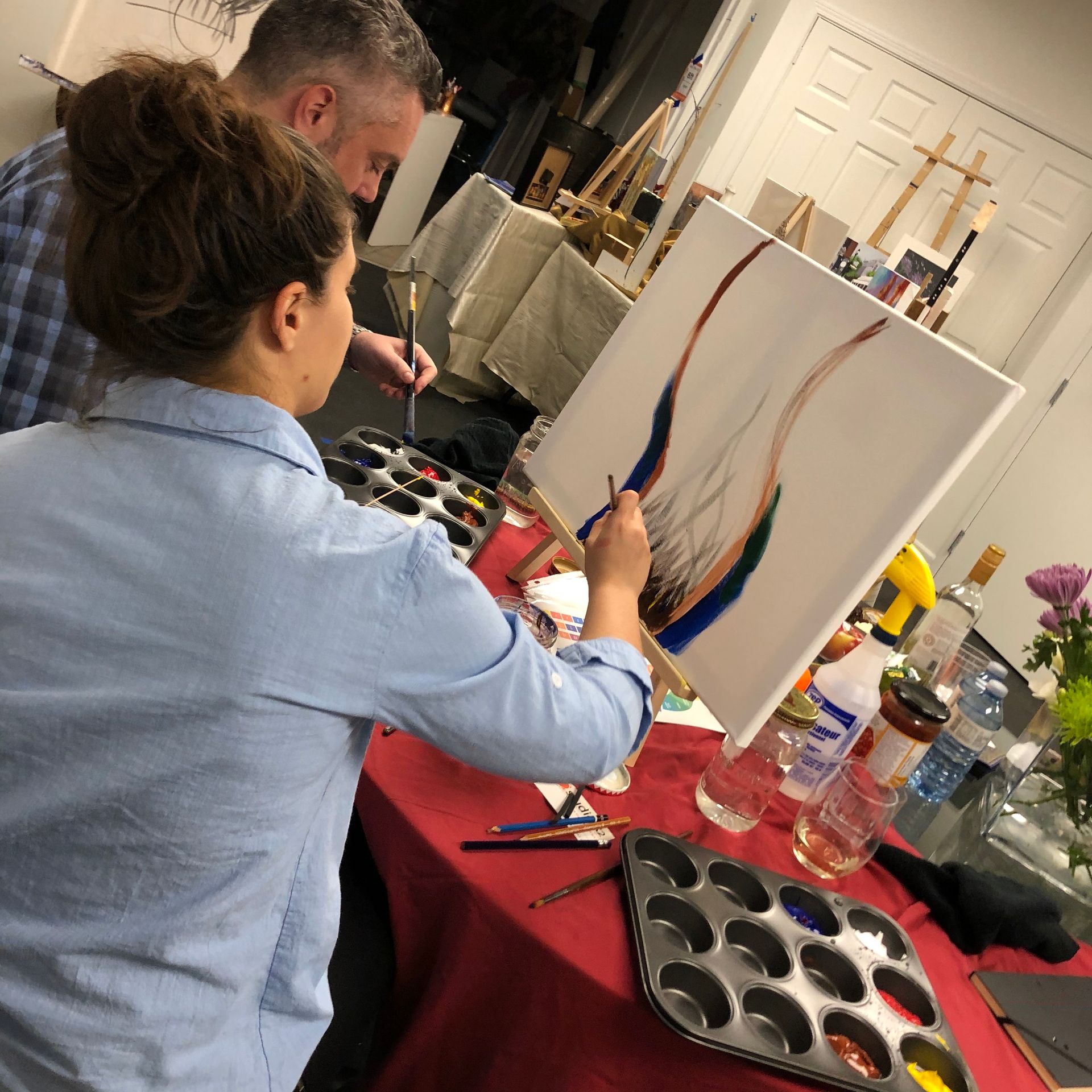 Datenight event showing couple working on a painting together.