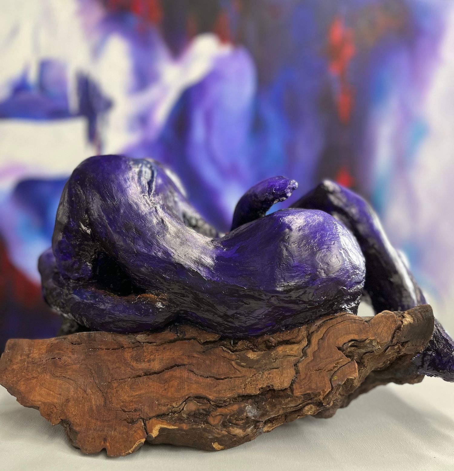 Sculpture by karen klucowicz of a couple mounted to cherry maple wood
