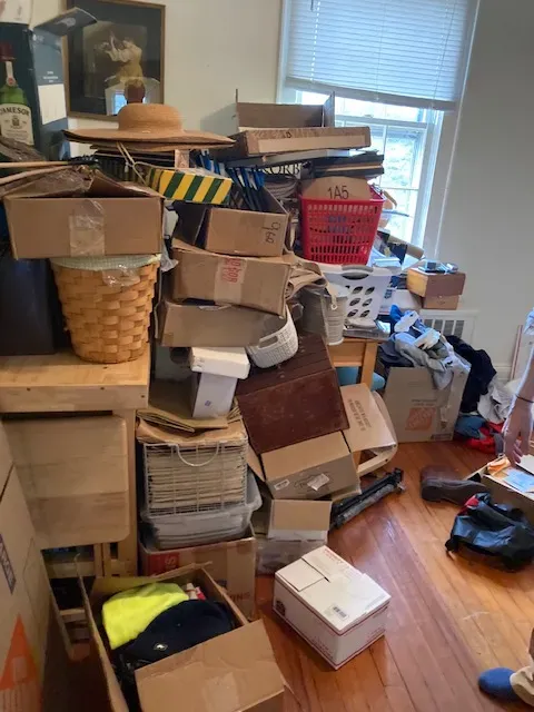 A room with a lot of boxes and baskets on the floor