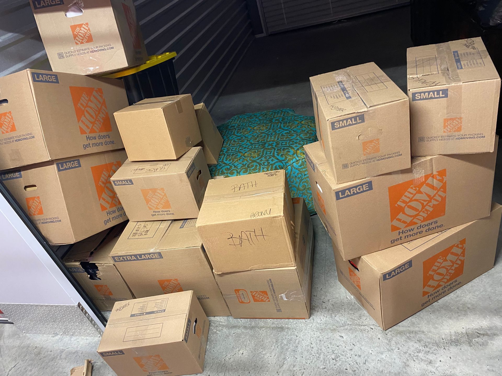 A pile of home depot boxes are stacked on top of each other.
