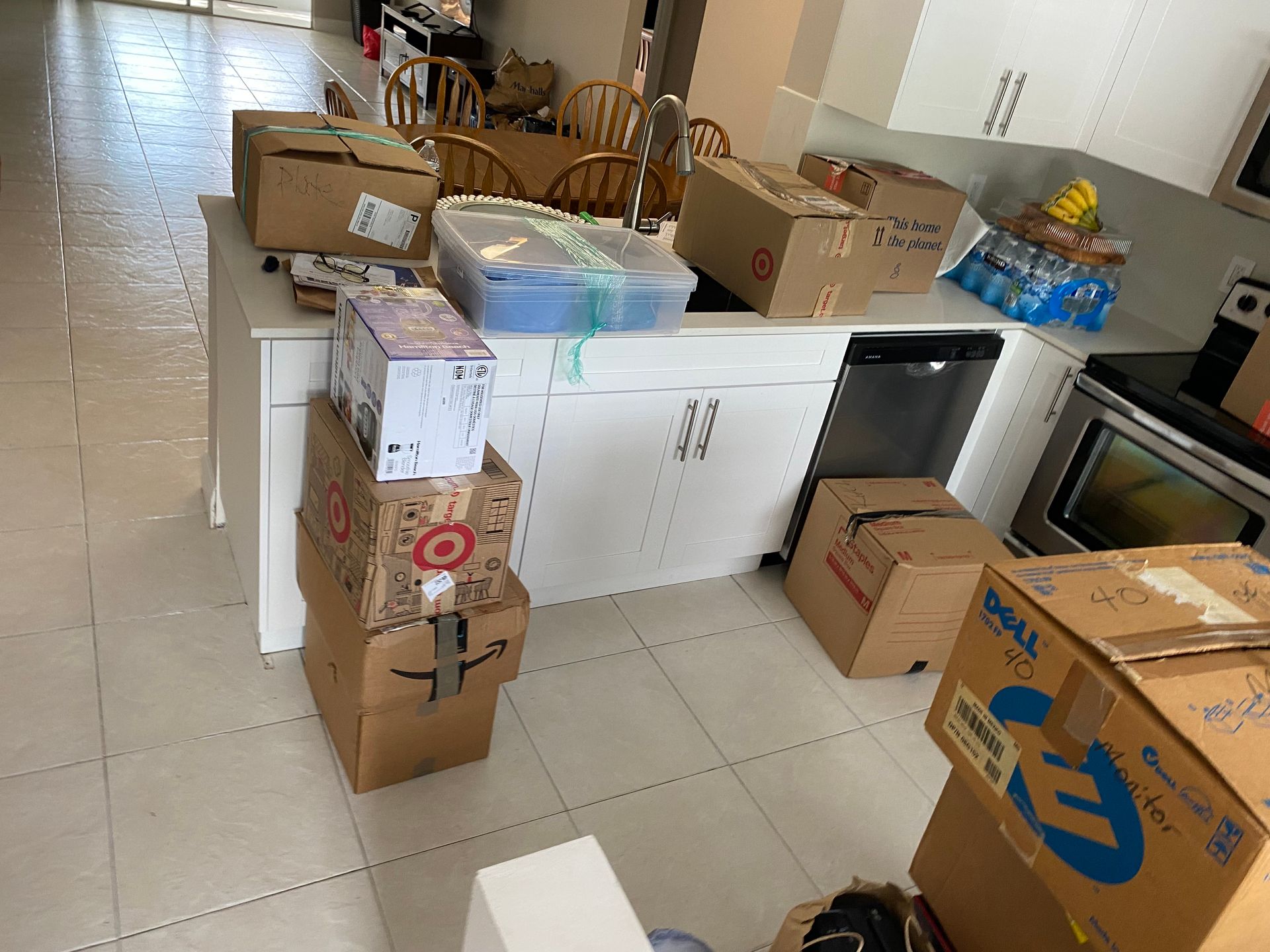 A kitchen with a lot of boxes on the floor
