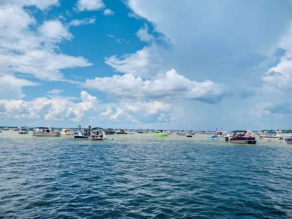 A group of boats are floating on top of a body of water. A group of boats are floating on top of a body of water.