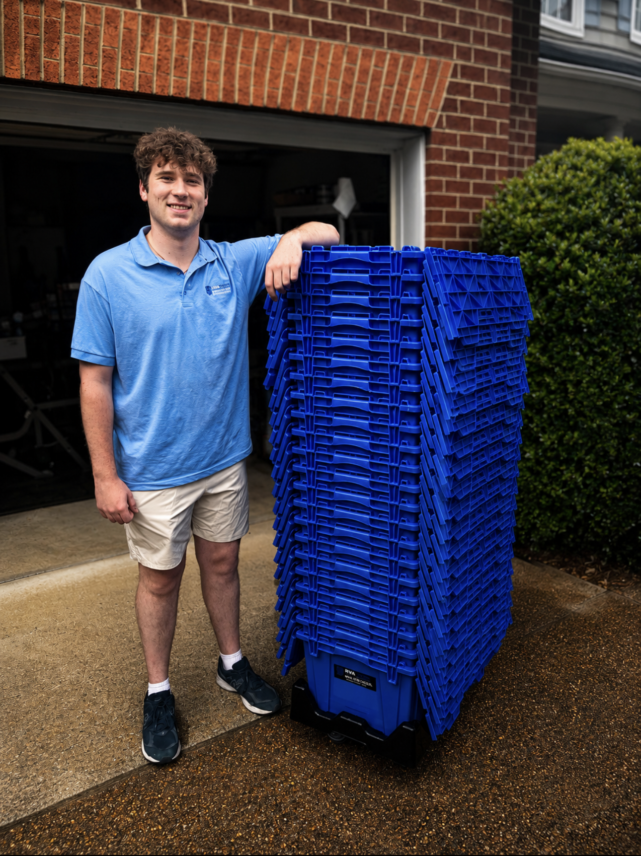 RVATotes team member standing beside a stack of reusable moving totes