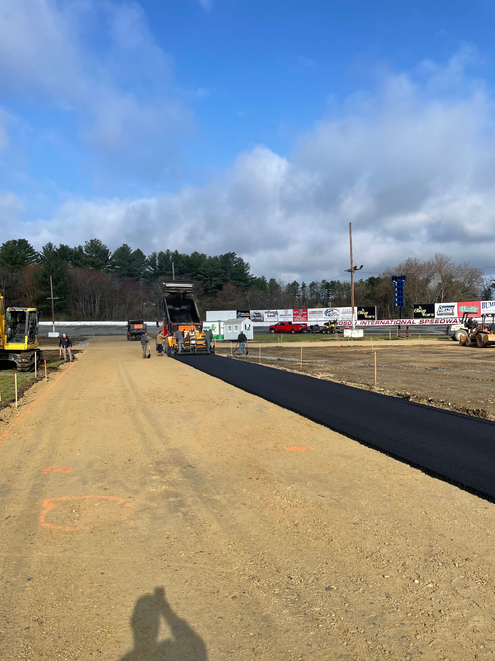 A road is being paved on a dirt road
