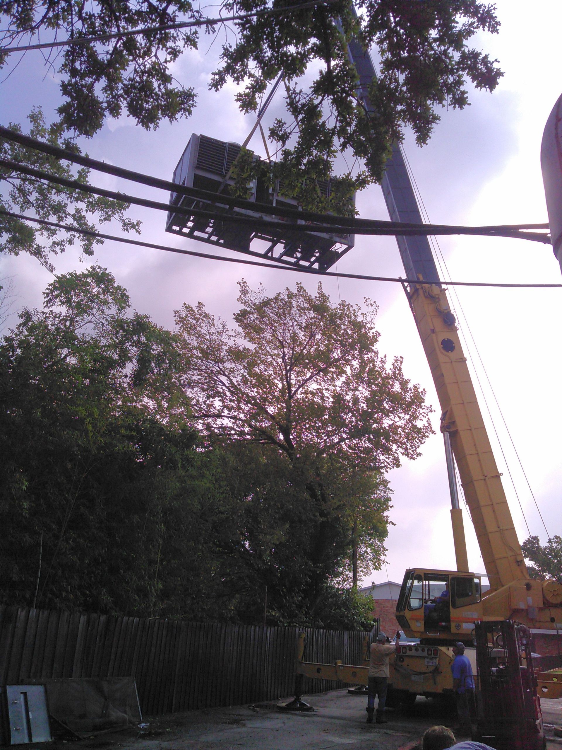 Tom's Commercial installing an HVAC unit at Edgewood Apartments