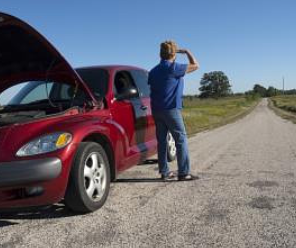 Red car with hood open, person on roadside looking frustrated.