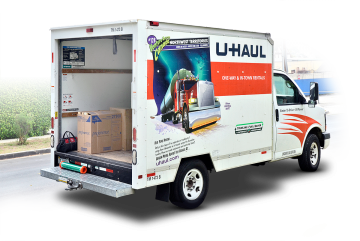 U-Haul moving truck, door open, with cargo inside, parked on a street.