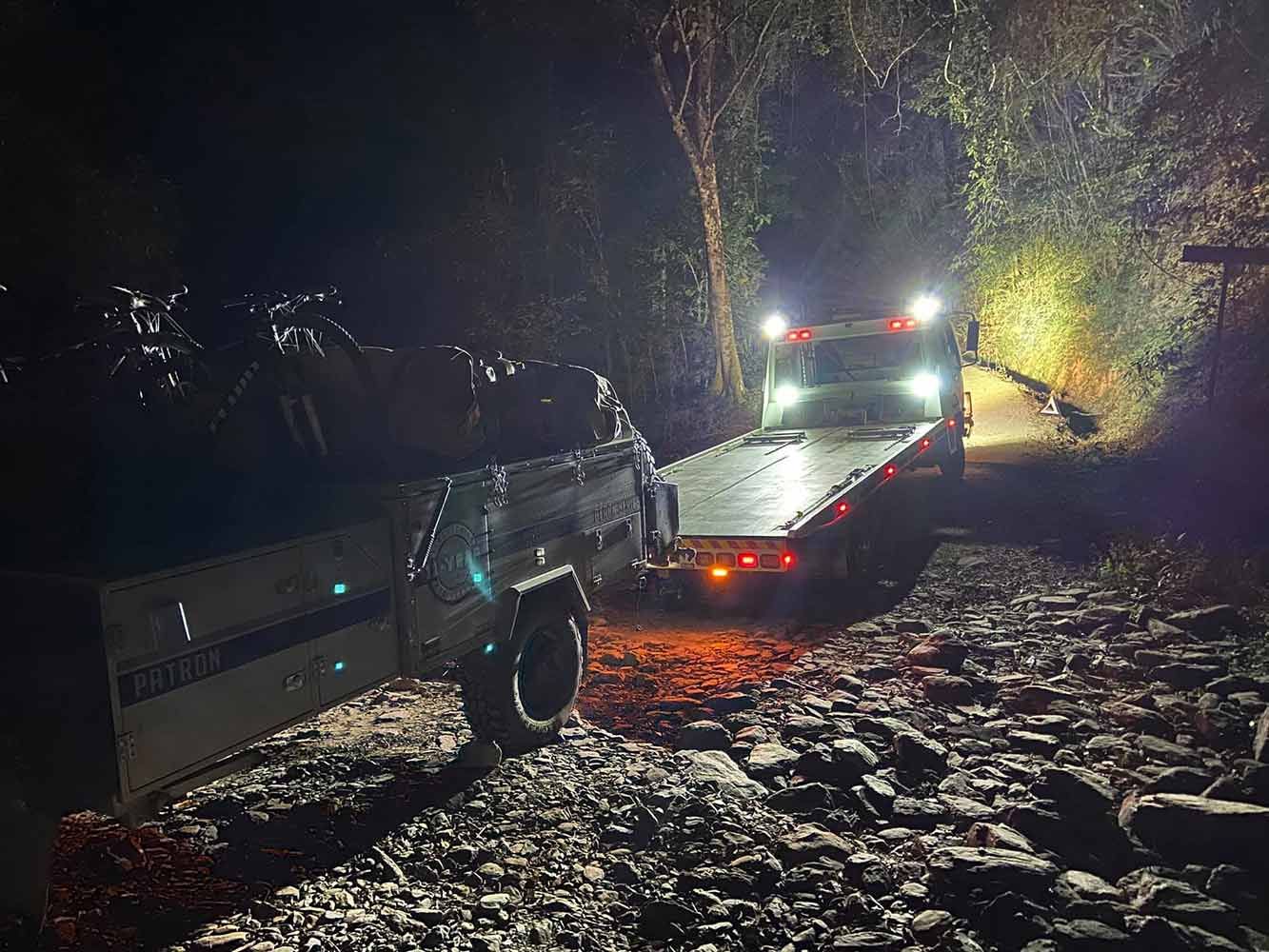 A Tow Truck is Towing a Truck on a Rocky Road at Night — Cape York Towing & Transport in Musgrave, QLD