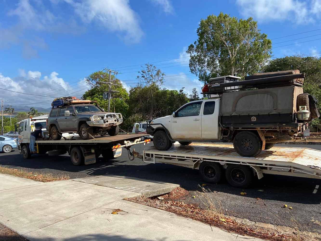 Two Trucks Are Sitting on Top of a Flatbed Truck — Cape York Towing & Transport in Bramwell, QLD