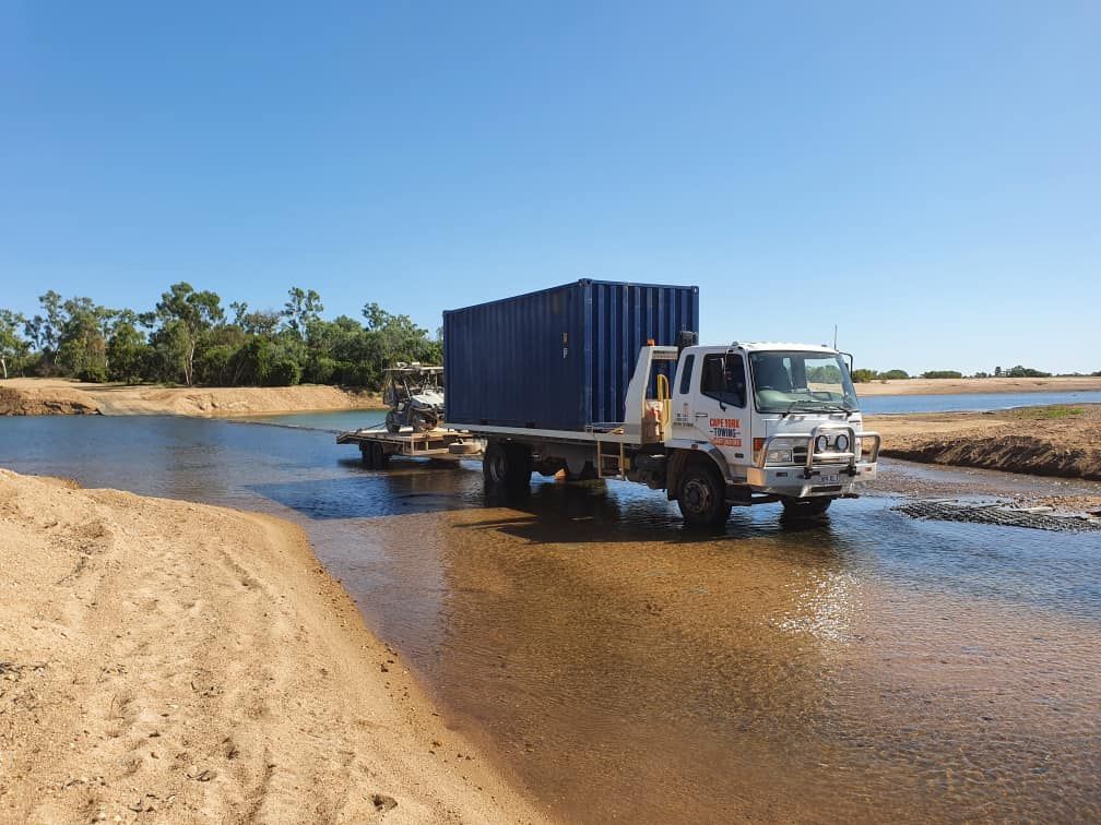 A Tow Truck With a Car on the Back is Parked on the Side of the Road — Cape York Towing & Transport in Chillagoe, QLD