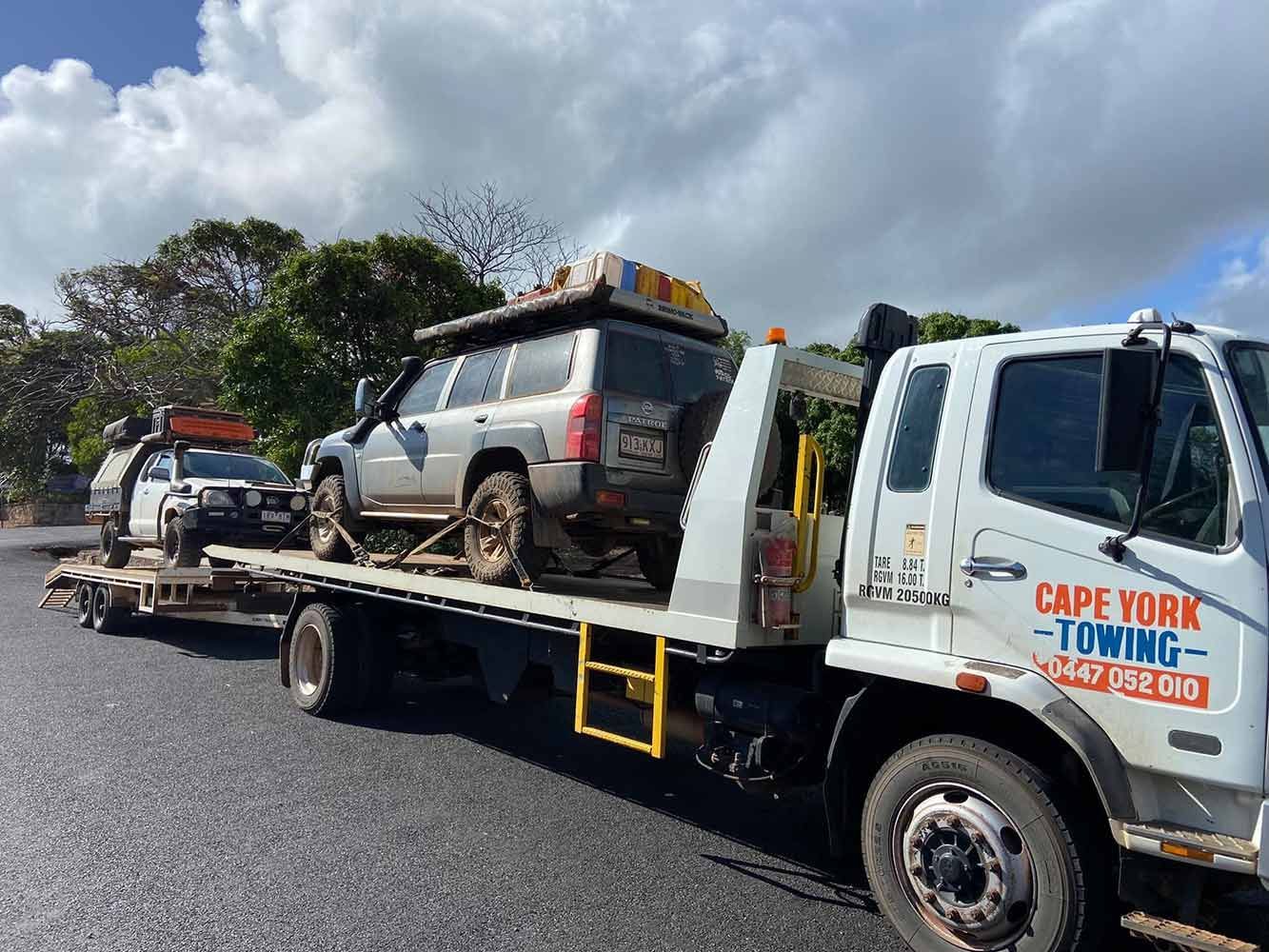 Two Cars Are Being Towed by a Tow Truck — Cape York Towing & Transport in Townsville, QLD